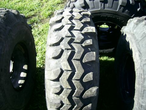 1978 Ford Bronco - Close-up of multiple off-road tires, with a focus on the tread of one.
