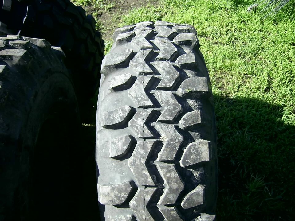 Tire tread with aggressive block pattern, close-up view