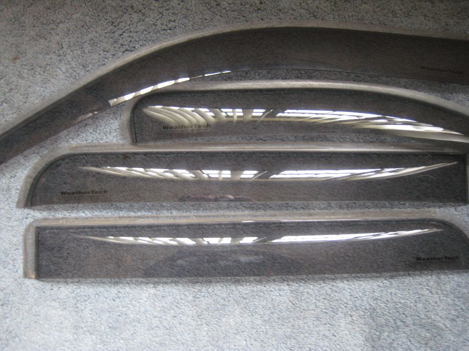 Four dark window visors with WeatherTech branding