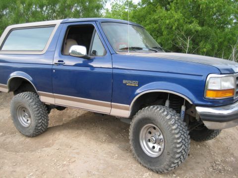 1996 Ford Bronco - This 1996 Ford Bronco is shown from a three-quarter front angle on a dirt path.