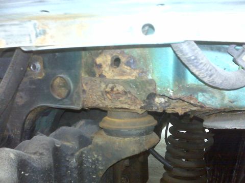 1996 Ford Bronco - The vehicle's frame shows significant rust damage, indicating potential structural issues.
