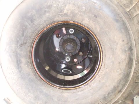 1987 Suzuki Samurai - This image shows a close-up view of a vehicle's wheel and tire assembly, focusing on the lug nuts and rim.