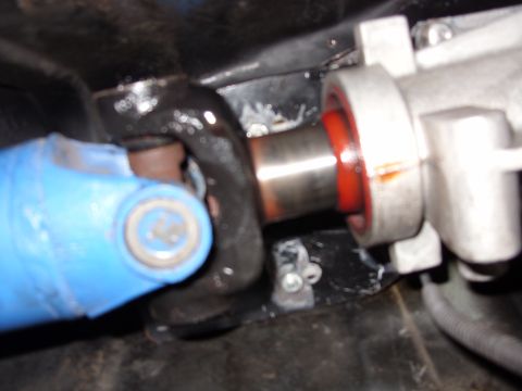 1978 Ford Mustang II - Tight close-up of a steering shaft U-joint coupled to a rack-and-pinion input shaft, with the blue-painted lower shaft and black universal…