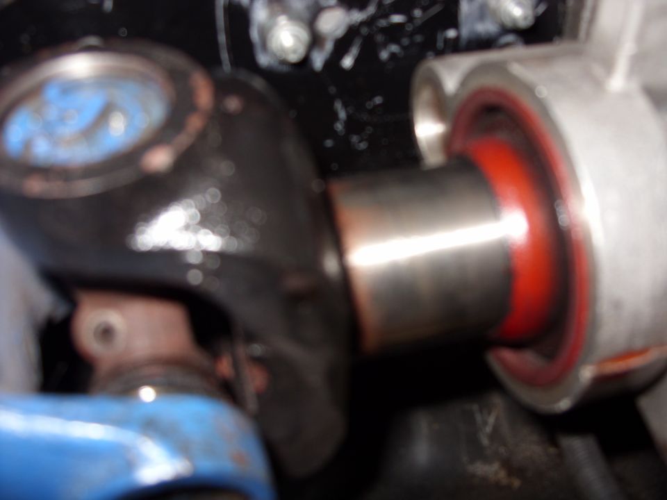 Close-up of chrome shaft in red polyurethane bushing inside aluminum housing