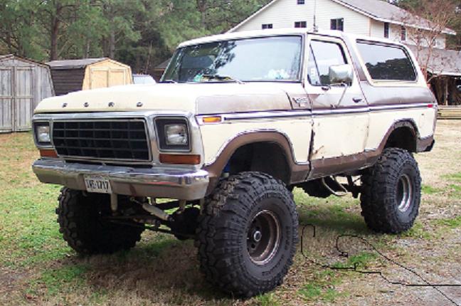 Lifted 1979 Ford Bronco, tan and brown, with large off-road tires