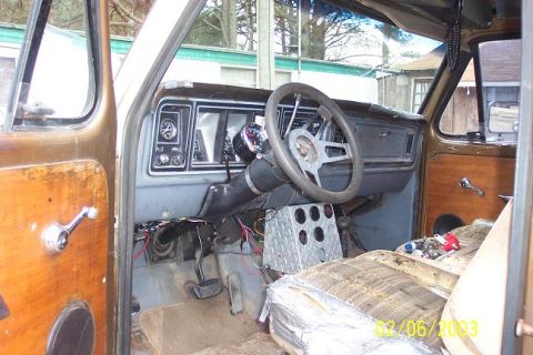 Interior of a brown 1973 Ford Bronco showing the dashboard, steering wheel, and driver's seat