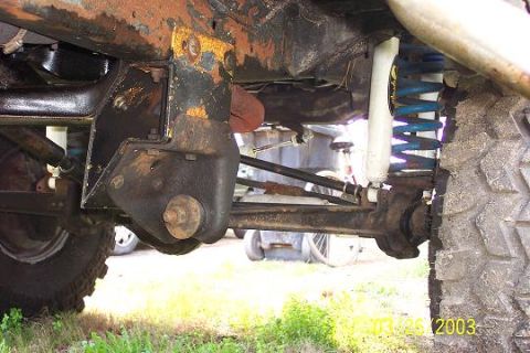 1979 Ford Bronco — Undercarriage view of a vehicle's suspension and large tire