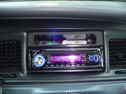 2000 Ford Crown Victoria - The dashboard features an aftermarket stereo and a small storage cubby above it.