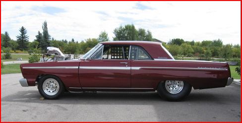 Dark red 1960s drag-style coupe with exposed blower, side view