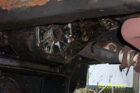 1979 Ford Bronco — Underside view of a vehicle's transmission housing and exhaust pipe