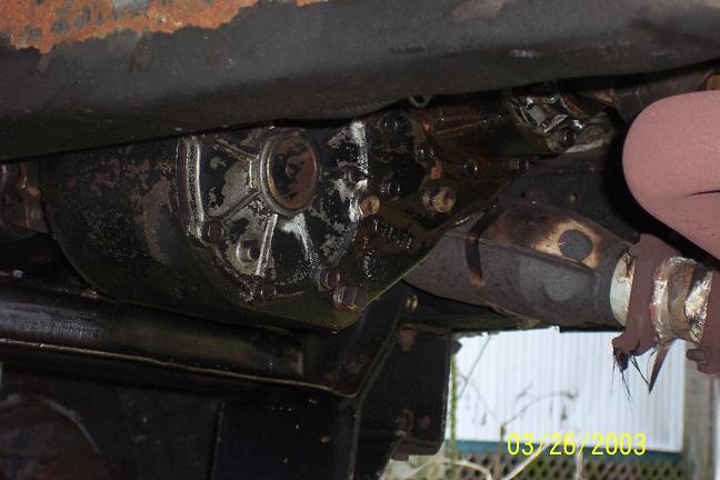Underside view of a vehicle's transmission housing and exhaust pipe