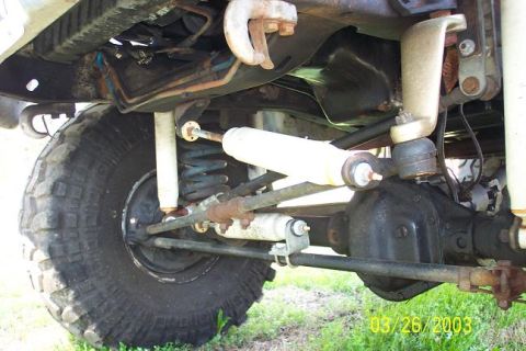 1979 Ford Bronco — Undercarriage view of a 4x4 with large tire, suspension, and differential