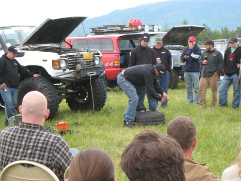 2000 Ford E350 - Group of people and modified off-road vehicles at an outdoor event.