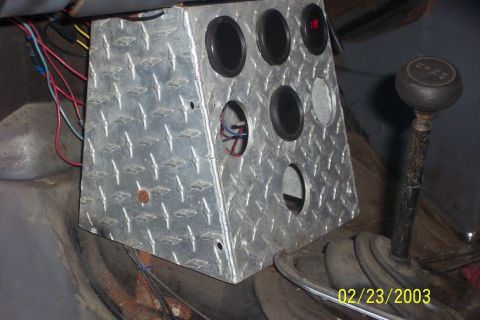 Diamond plate gauge pod with multiple holes and a shifter knob with '4WD' text