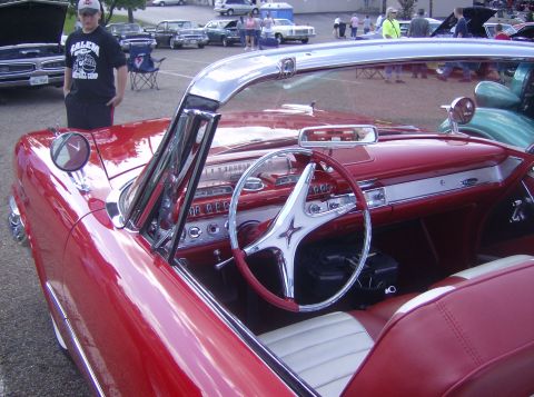 1970 Ford Ranchero - The interior of a red convertible shows off its classic design and chrome accents.