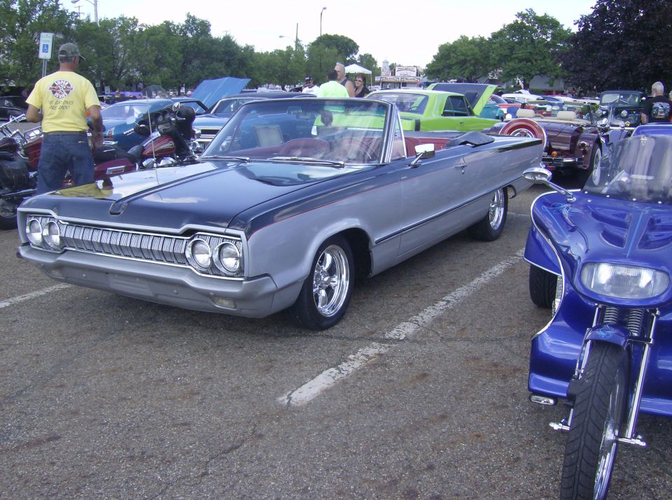 Silver and dark blue convertible with chrome grille and wheels