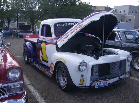 1970 Ford Ranchero - Customized pickup truck with racing livery and open hood at an outdoor event.