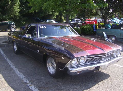 1970 Ford Ranchero - A custom 1969 Chevrolet El Camino SS with a two-tone paint job is displayed at an outdoor event.