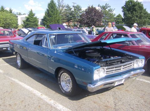 1970 Ford Ranchero - Blue 1969 Plymouth Road Runner displayed at an outdoor car show event.