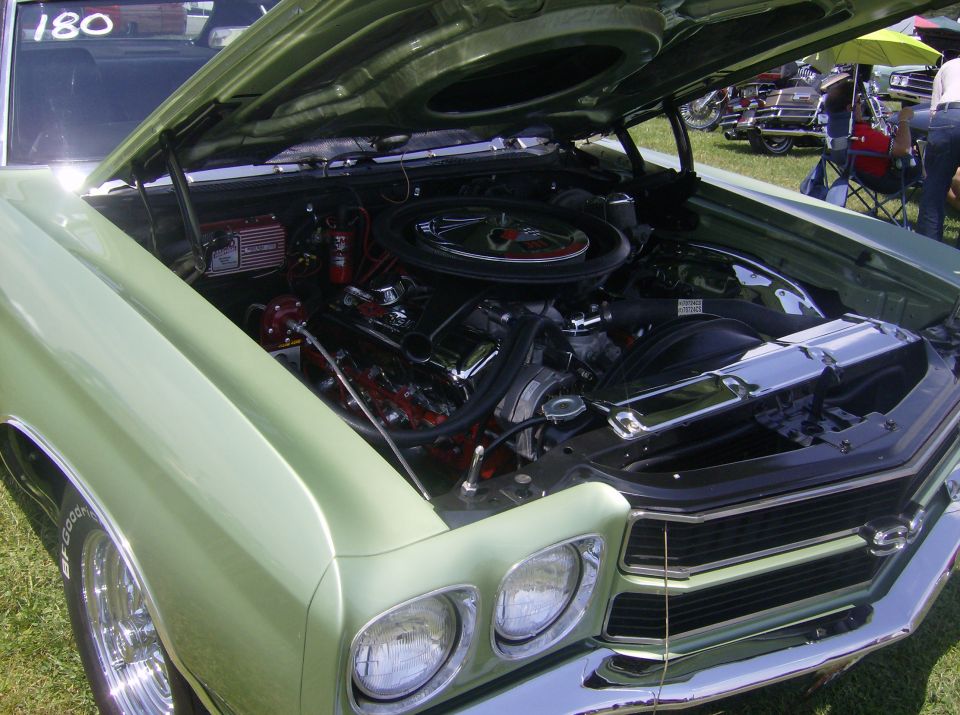 Light green 1970 Ford Ranchero with hood open, showing a V8 engine and chrome accents