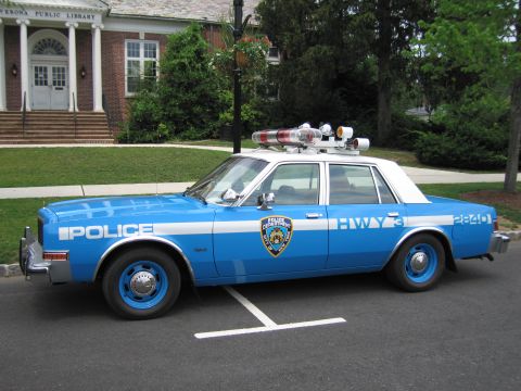 1991 Ford LTD Crown Victoria - Side profile of a blue-and-white NYPD Highway Patrol Dodge sedan, car 2840, parked in front of the Verona Public Library.