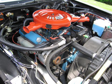 1991 Ford LTD Crown Victoria - restored V8 engine bay featuring an orange 440 Four Barrel air cleaner atop a blue-painted block.