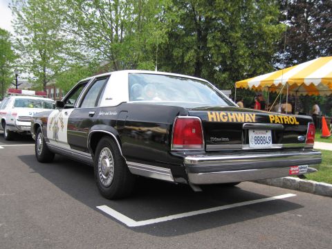 1991 Ford LTD Crown Victoria - Rear three-quarter of a black-and-white Ford Crown Victoria lettered Highway Patrol, Safety and Service.