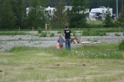 1990 Chevrolet Suburban - Children in a field with RVs visible in the background.