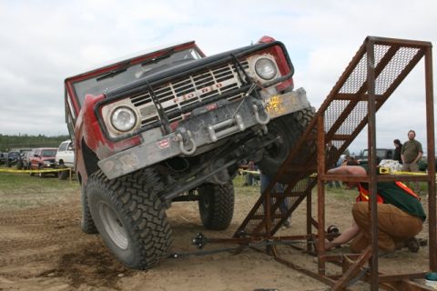 1990 Chevrolet Suburban - Ford Bronco navigates an off-road obstacle course during an event.