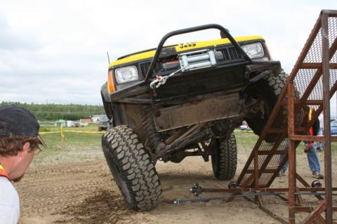 1990 Chevrolet Suburban - A modified Jeep Cherokee XJ navigates an off-road obstacle course.