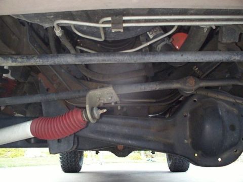 2001 Ford E150 - Undercarriage view of a 2001 Ford E150, highlighting suspension and drivetrain parts.