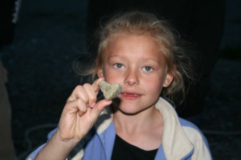 1990 Chevrolet Suburban - A young girl holds up a heart-shaped rock she found.