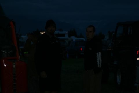 1990 Chevrolet Suburban - Two men stand in front of a dark colored vehicle, possibly a Chevrolet Suburban, at dusk. A red jerry can is visible on the left side of th…