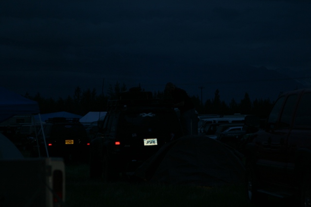 Rear view of a dark SUV at night with license plate JP5F8I.