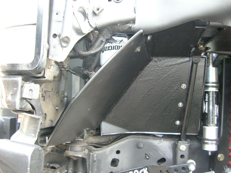 Truck front inner fender with Motorcraft oil filter and remote-reservoir racing shock
