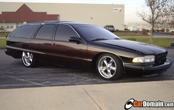 Black Chevrolet Caprice wagon lowered on chrome wheels