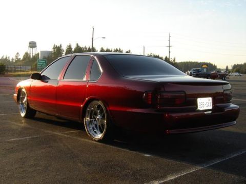 1998 Ford Crown Victoria - Rear three-quarter view of a dark red Chevrolet Impala SS sedan parked at dusk.