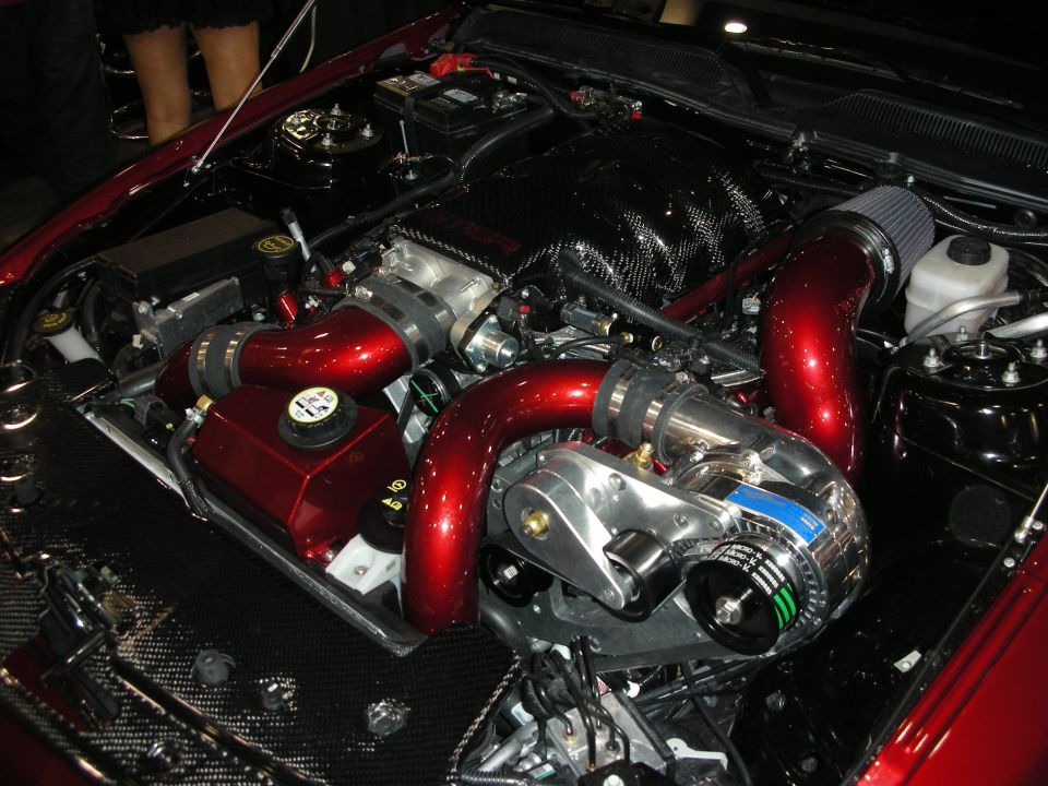 Supercharged engine bay with red intake piping