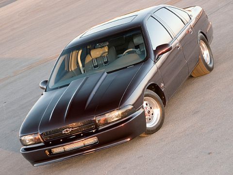 1998 Ford Crown Victoria - Elevated front three-quarter view of a black Chevrolet Impala SS sedan on a paved lot.
