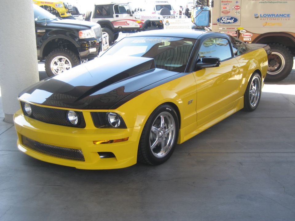 Yellow and black Ford Mustang GT at an outdoor show