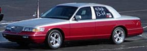1998 Ford Crown Victoria - Photograph of a red Mercury Grand Marquis sedan.