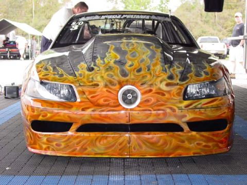 1998 Ford Crown Victoria - Photograph of the front of a tube-chassis drag car with orange flame airbrush paintwork.