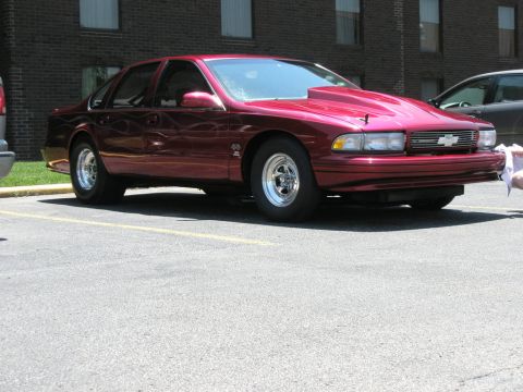 1998 Ford Crown Victoria - Photograph of a dark red Chevrolet Caprice/Impala sedan parked outdoors.