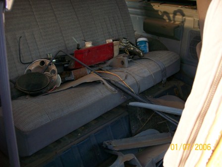1988 Ford Bronco - Vehicle interior filled with various parts and debris, obscuring clear identification of make or model.