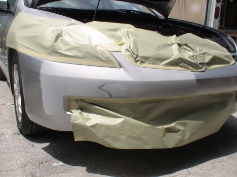 1993 Ford C-350 (Centurion Conversions) - A car's front end is covered in masking paper, preparing for paintwork.
