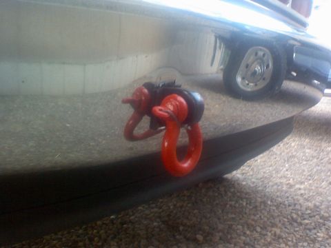 1993 Ford Bronco - Close-up of a red tow hook on a vehicle bumper with a wheel in the background.