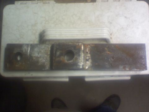 1993 Ford Bronco - A close-up shot of a rusty metal bracket with two mounting holes.