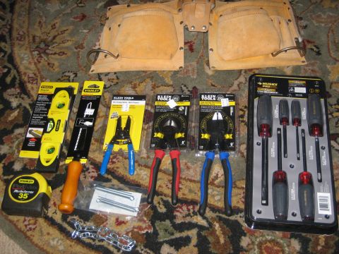 1995 Ford Bronco - Collection of hand tools including a tape measure, level, pliers, and screwdrivers.