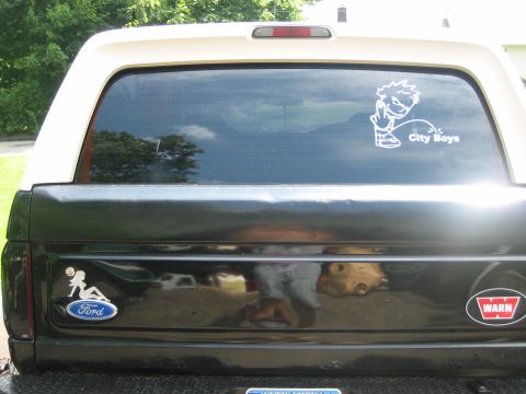 1995 Ford Bronco - This Ford Bronco features a 'City Boys' decal on the rear window and a Ford logo on the tailgate.