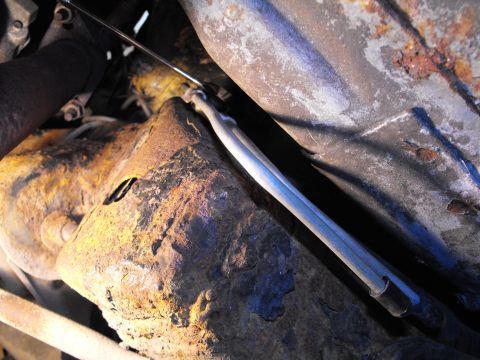 1990 Lincoln Town Car - A couple of nearly perfect 90 degree bends secured tight to the frame rail by the factory clamp and that great ratchet wrench.